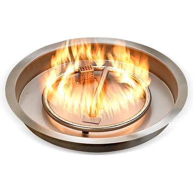 Lit Travertine T&M round stainless steel drop-in pan burner kit showing natural yellow flames from the ring burner.