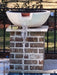 White Travertine TessaRai fire and water bowl with copper scupper spillway mounted on brick pool pedestal.