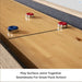 Close-up of the seamless center connection on the Freetime Fun Rockford 2-piece shuffleboard table play surface with pucks.