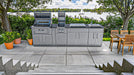 Sunstone Alamo Hybrid Grill Island 10 ft on lakeside patio with open grill, side griller, sink, and cabinet storage
