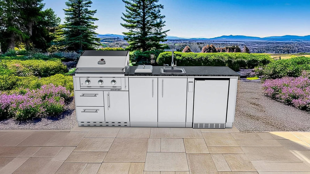 Outdoor kitchen run installed on stone patio with scenic garden and mountain view with Sunstone SCPBAYOU8.6 Bayou Outdoor Kitchen Island 8'6".