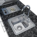 Close-up of Sunstone SCPBAYOU8.6 Bayou Outdoor Kitchen Island 8'6" sink and drop-in side burner on dark granite countertop.