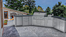 Sunstone Big-Texan 21ft outdoor kitchen island on modern patio with curved corner cabinets, stainless grill, side burner, fridge, and sink.