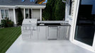 Sunstone SCPBRAZOS9 Brazos 9-foot outdoor kitchen island with a built-in gas grill and sink installed on a modern concrete patio.
