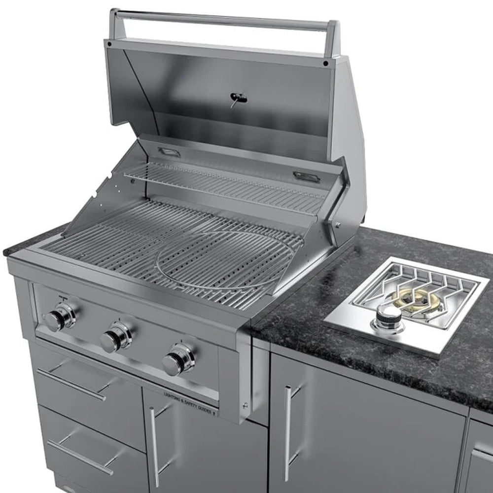 Three-quarter perspective of the Sunstone Brazos outdoor island showing the integrated drop-in side burner and the open Ruby Series gas grill with 304 stainless steel construction.