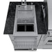 Detailed view of the Sunstone Caprice outdoor kitchen sink with the cover removed, showing the stainless steel basin, drain strainer, and dual condiment or ice bins.