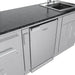 Sunstone SCPFRENCHQUARTER13.7 French Quarter Island under-counter stainless refrigerator next to sink base cabinets beneath black granite.