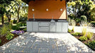 Sunstone SCPGALLEY10.8 Galley Clean & Prep Island installed outdoors on patio, stainless cabinets with granite top, sink and prep stations.