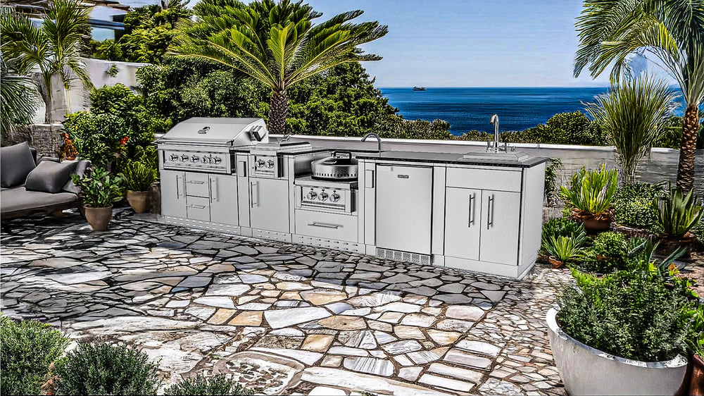 Luxury coastal installation of the Sunstone SCP-HILLCOUNTRY-13.6 outdoor kitchen on a stone mosaic patio with ocean views and palm trees.