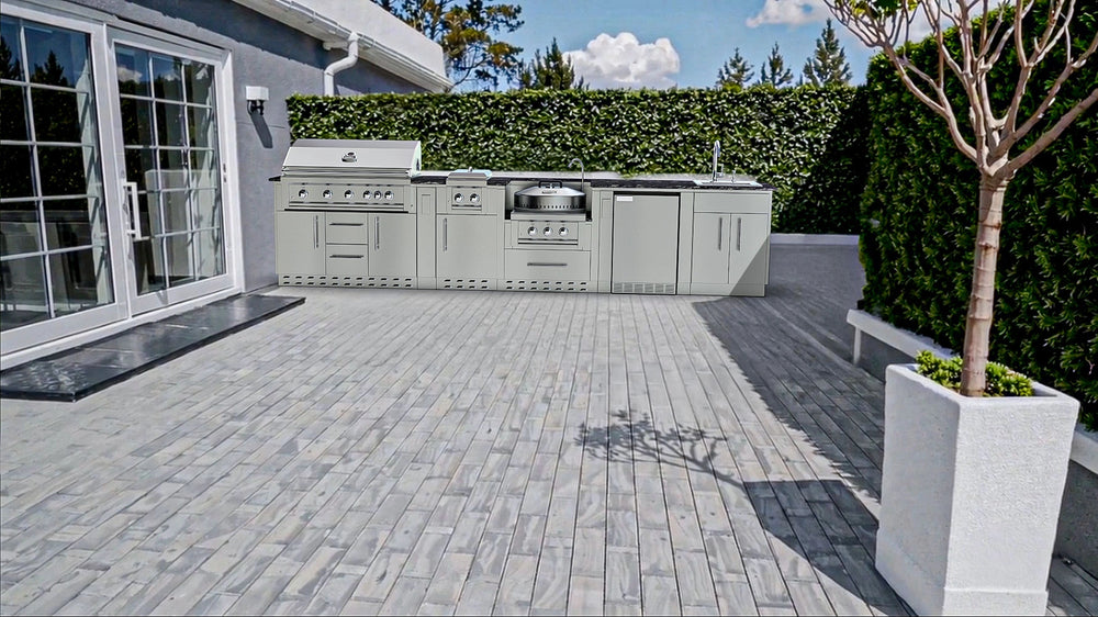 Sunstone Hill Country 13.6 outdoor kitchen island installed on a modern grey paver patio with a lush green privacy hedge background.
