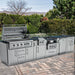 Realistic backyard setting for the Sunstone Hill Country 13.6 island featuring the Ruby grill with the hood open, demonstrating the rotisserie and cooking space.