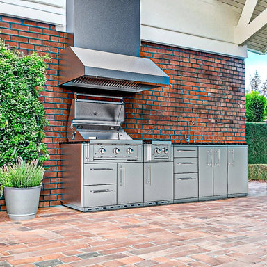 Sunstone SCPMAGNOLIA10 Magnolia ADA outdoor kitchen island installed on brick patio with vent hood, Ruby grill, side burner, sink, and storage cabinets.