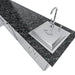 Sunstone Rancher L-shaped island (SCPRANCHER8.10BY11) close-up of sink cover and faucet set into black granite countertop.