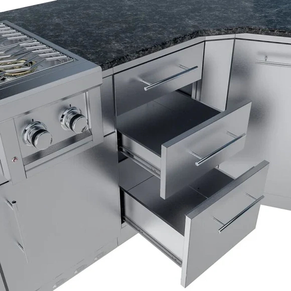 Close-up of triple-tier stainless steel storage drawers integrated into an angled outdoor kitchen island.