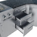 Close-up of triple-tier stainless steel storage drawers integrated into an angled outdoor kitchen island.