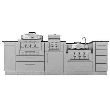 Straight-on view of the complete 9ft Sunstone TexCajun outdoor kitchen island, showcasing the sink, multiple burner controls, flexible faucet, and unified cabinet and drawer system with dark granite counters.