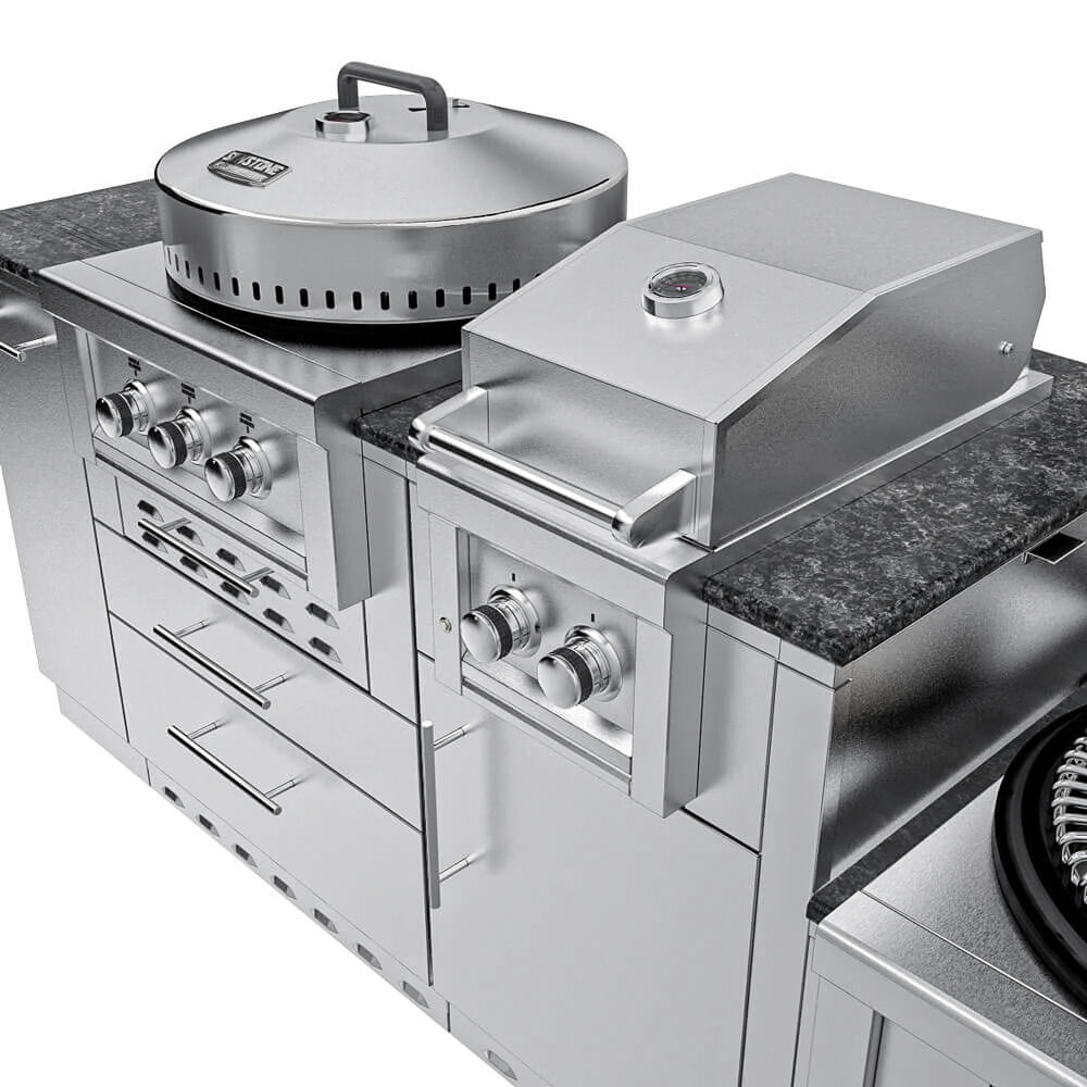 Eye-level shot of the same Sunstone TexCajun configuration, but with both the power burner cover and main grill hood closed, on a dark granite countertop against a stone wall background.