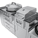 Eye-level shot of the same Sunstone TexCajun configuration, but with both the power burner cover and main grill hood closed, on a dark granite countertop against a stone wall background.