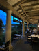 Commercial restaurant dining deck utilizing a row of overhead SunStar SGL0 gas heaters to maximize floor space.