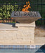 Travertine TessaRai 36 inch Square Fire Bowl Kit close-up with lava rock fire feature on stacked stone pool pedestal