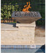 Travertine TessaRai 36 inch Square Fire Bowl Kit with lava rock on poolside stone pedestal in sunny backyard