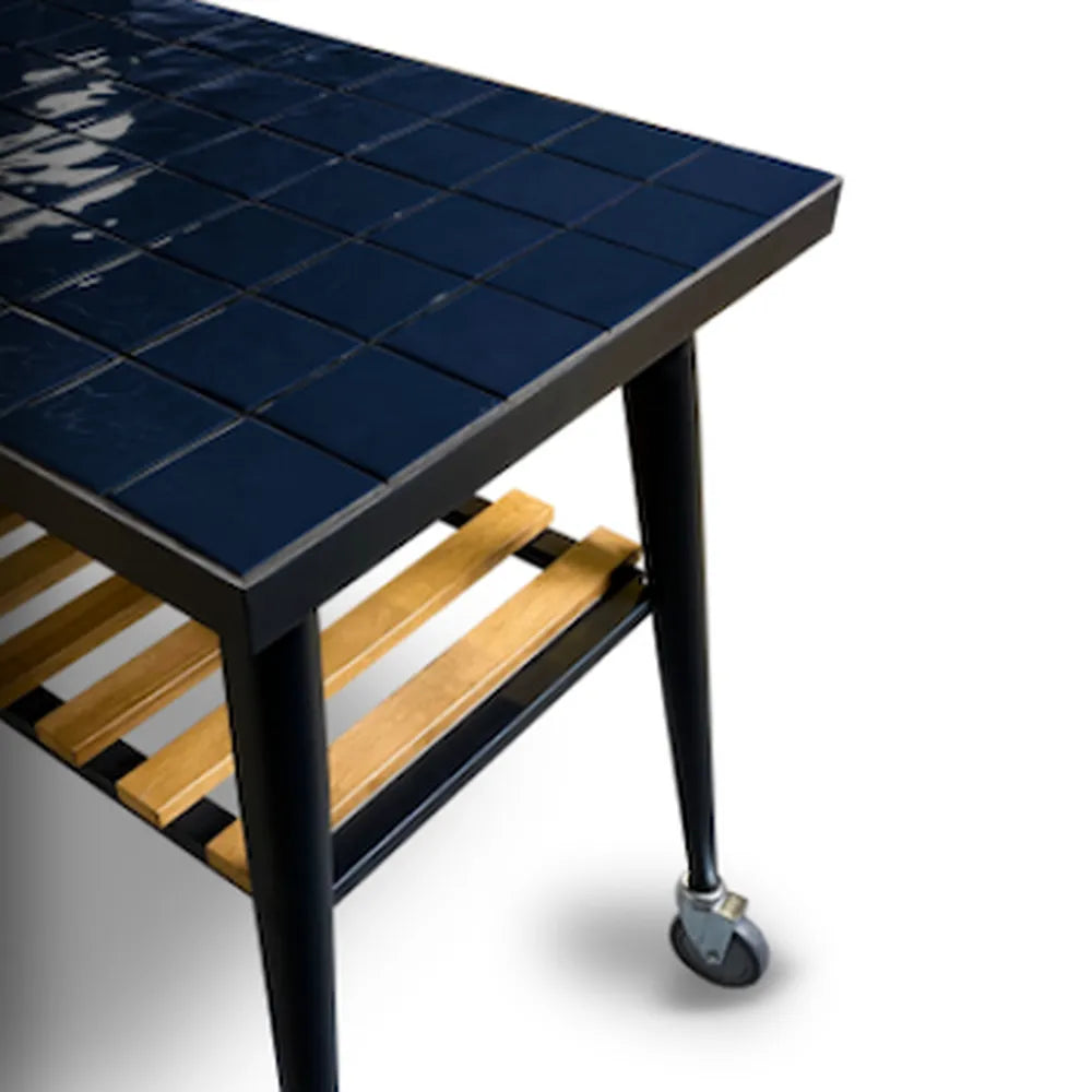 WPPO Infinity 103cm side table with glossy blue tile top, black metal frame, caster wheel, and wood slat shelf.