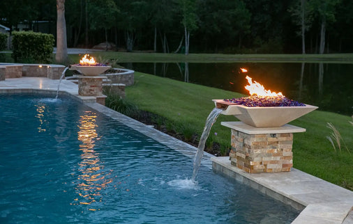 Pair of Travertine TessaRai Square Fire/Water Bowl Kits on stone pedestals beside contemporary courtyard pool