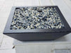 Travertine TessaRai 36 inch Square Fire Bowl Kit filled with reflective fire glass on modern white pool ledge