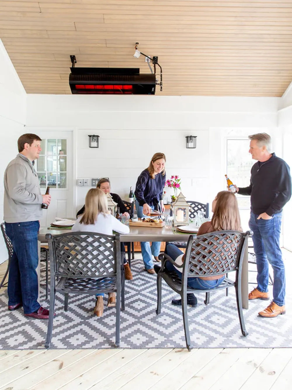 Sleek black SunStar SGL1560 glass-faced heater blending seamlessly into a modern ceiling patio design.