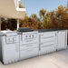 Outdoor kitchen island featuring Sunstone SAC34DWC 34" double warming drawer cabinet installed beside grill and side burner in stainless setup.
