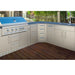 Complete stainless steel outdoor kitchen featuring the Sunstone SBC3C45 corner cabinet, a built-in gas grill, and sink station with blue countertops.
