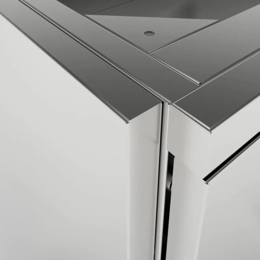 Close-up architectural detail of a Sunstone SCC27EP 27-inch stainless steel universal end panel showing the precision mitered corner and seamless fit against an outdoor kitchen cabinet.