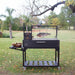 Tagwood BBQ03SI Santa Maria grill with whole fish hanging on adjustable hooks over charcoal