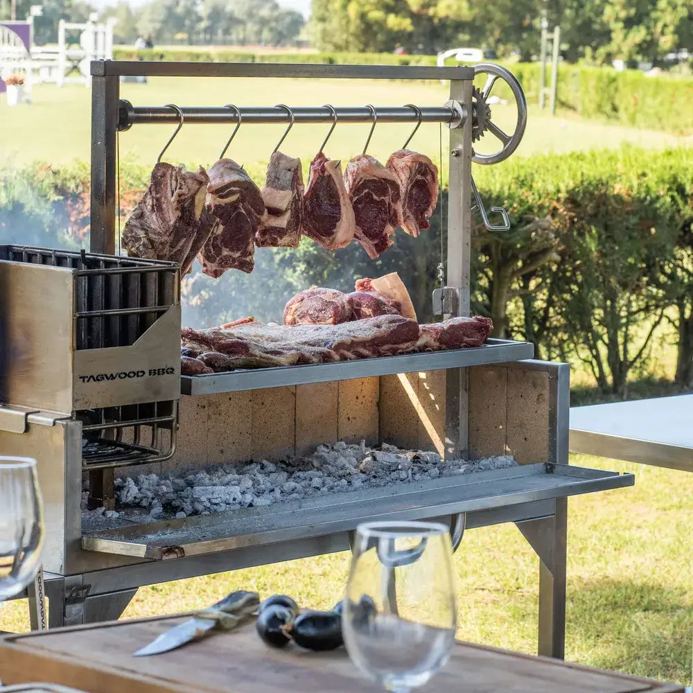 Tagwood BBQ03SS Santa Maria grill close-up cooking steaks over charcoal bed