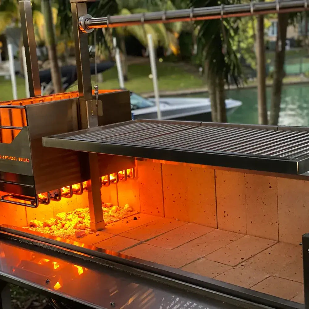 Tagwood BBQ03SS Santa Maria grill side brazier with flames and cooking grate above
