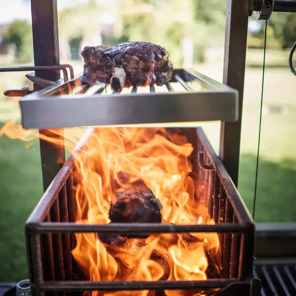 Tagwood BBQ03SS Santa Maria grill firebox with glowing embers and sparks at night