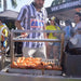 Tagwood BBQ03SS Mini Santa Maria grill cooking sausages at outdoor barbecue festival