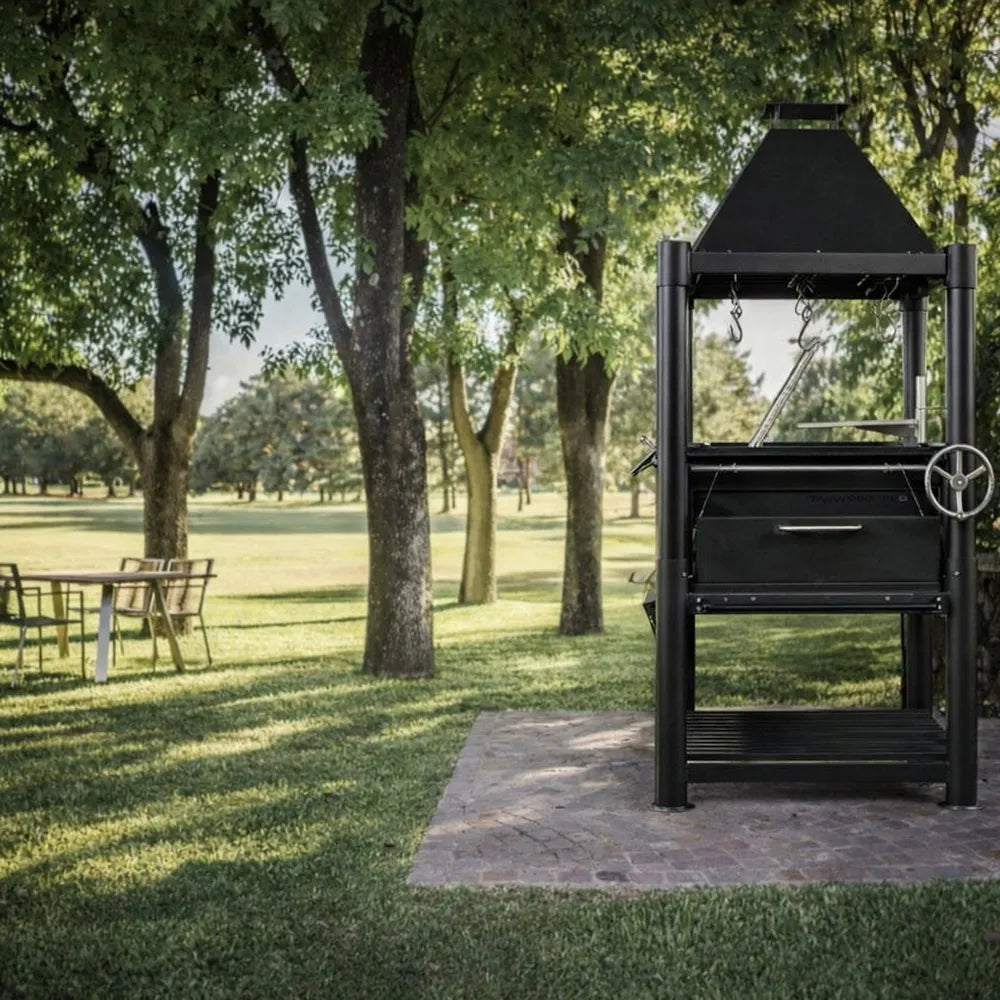 Tagwood BBQ BBQ12SI Santa Maria grill with chimney and lower log storage on lawn