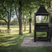 Tagwood BBQ BBQ12SI Santa Maria grill with chimney and lower log storage on lawn