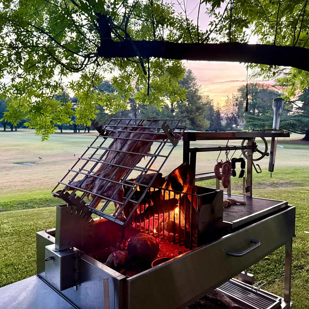 Tagwood BBQ26SS XL Santa Maria grill firebox charcoal basket with wood burning flames close up