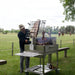 Tagwood BBQ33SS Argentine clamp grill chef grilling ribs using vertical clamp grate outdoors