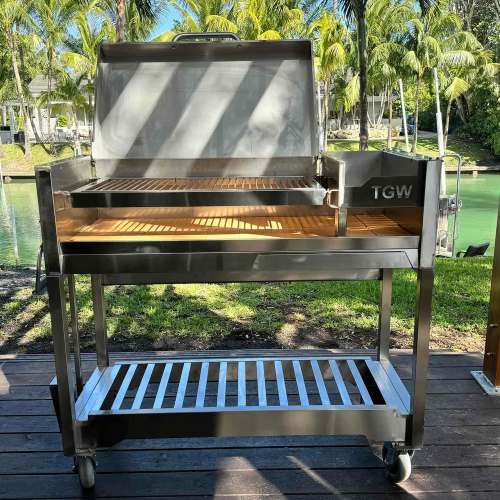 Tagwood BBQ18SS stainless steel Gaucho charcoal grill front view with lid open outdoors