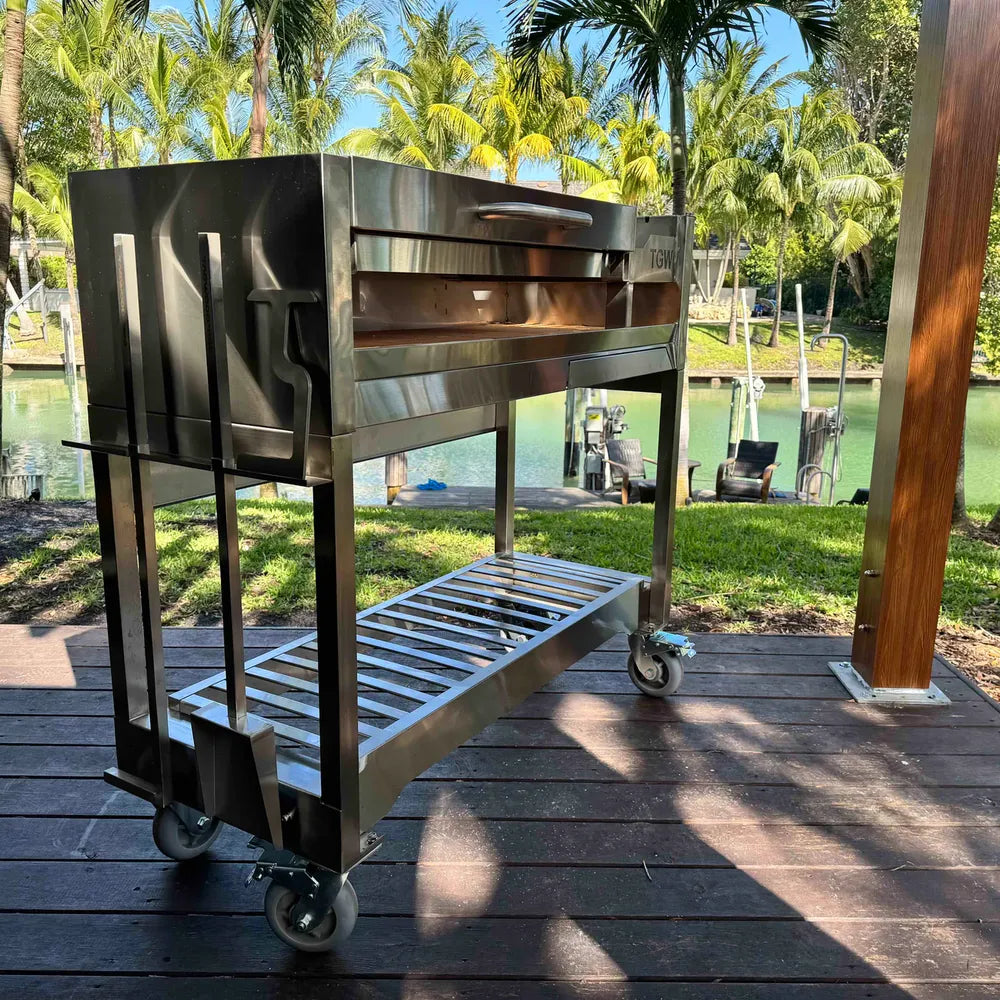 Tagwood BBQ18SS Gaucho grill angled side view on cart with heavy-duty caster wheels
