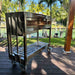 Tagwood BBQ18SS Gaucho grill angled side view on cart with heavy-duty caster wheels