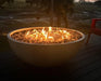 Travertine TessaRai 40 inch Patio Fire Pit Kit with wide circular flame display on elevated deck near marsh landscape