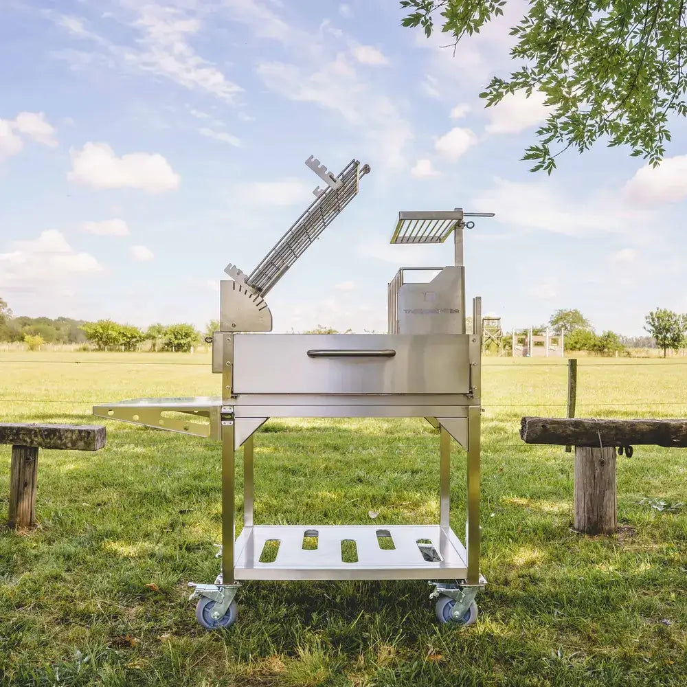 Tagwood BBQ33SS Argentine clamp grill open firebox showing firebrick lining and charcoal basket