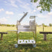Tagwood BBQ33SS Argentine clamp grill open firebox showing firebrick lining and charcoal basket