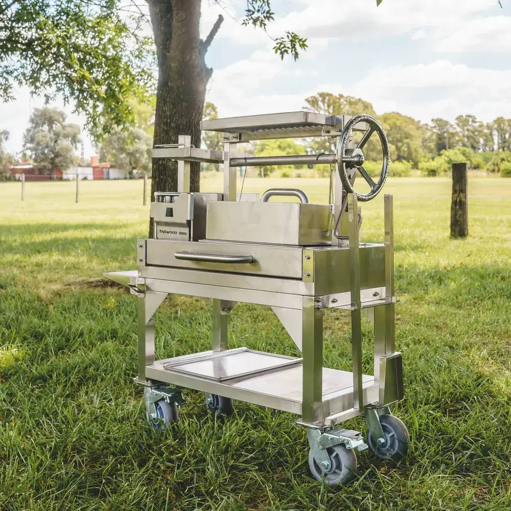 Tagwood BBQ03SS Mini Santa Maria grill angled side view on cart in grassy park