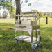 Tagwood BBQ03SS Mini Santa Maria grill angled side view on cart in grassy park