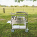 Tagwood BBQ03SS Mini Santa Maria grill with lid accessory on grassy field outdoor setting